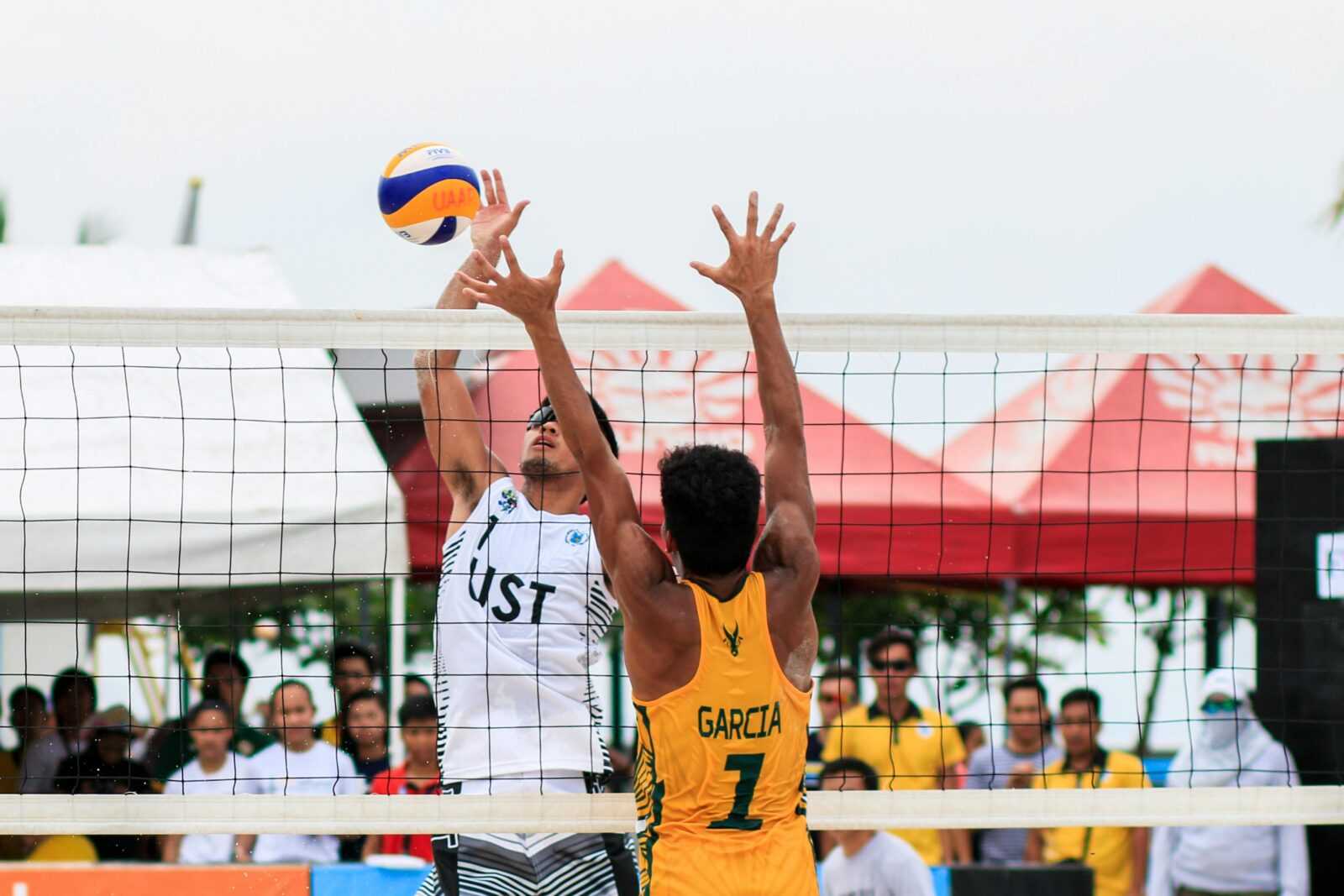 Beach volleyball action shot of two players competing at a tournament in Pasay, Philippines.